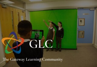 Student filming classmates against a green screen, branded with the GLC (The Gateway Learning Community) logo